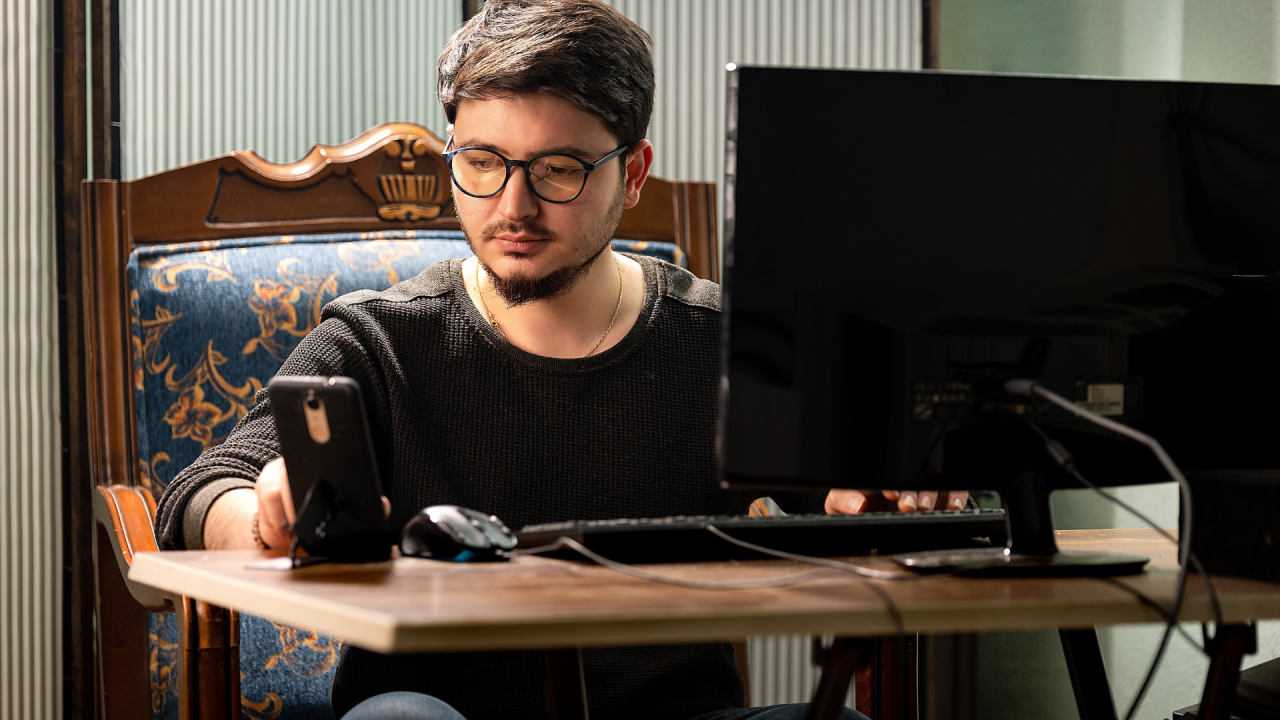 Man learning from mobile phone and laptop